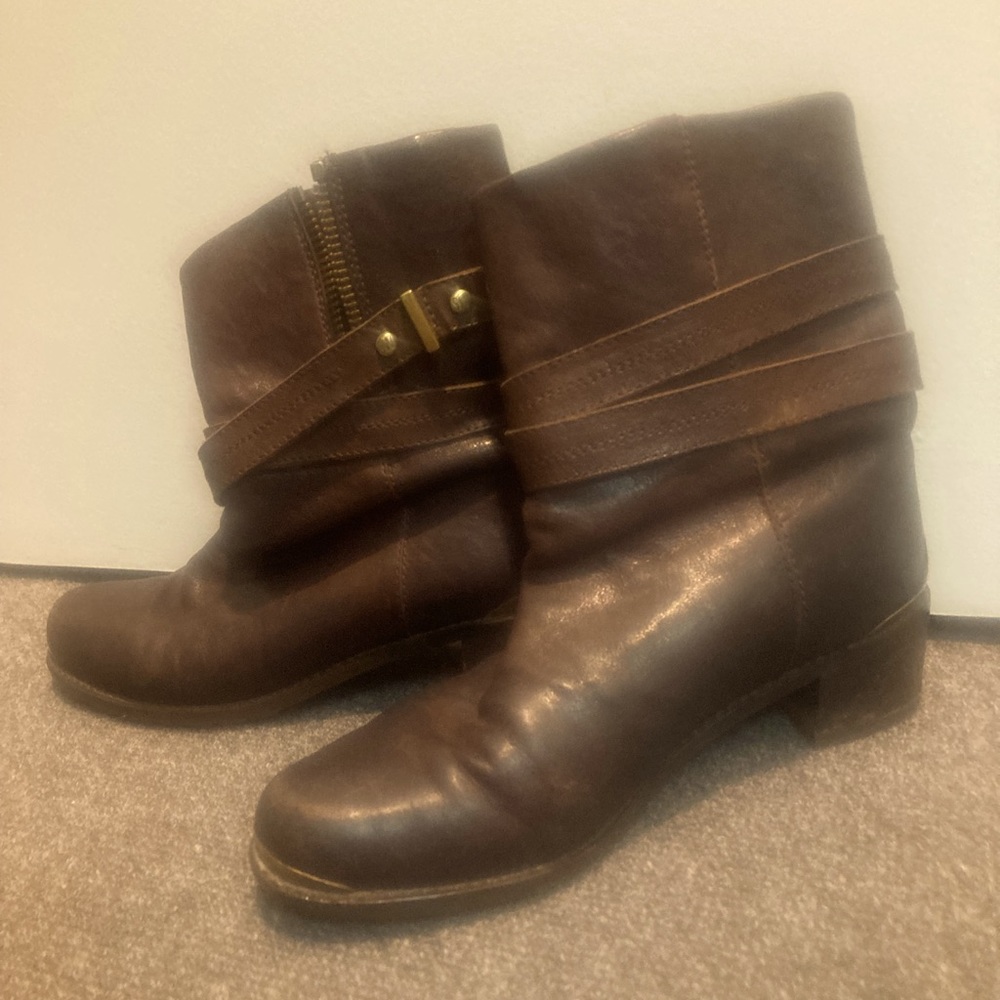 Brown leather boots with brass hardware